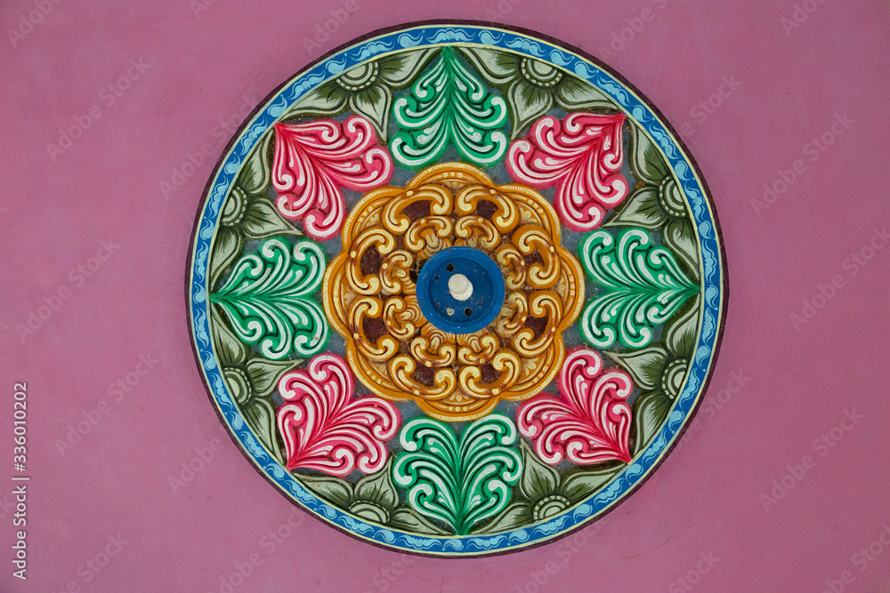 Ceiling of Meenakshi Sundareswarar Temple in the South India, beautiful vintage ceiling paintings with pattern and lamp in the center in an Indian temple