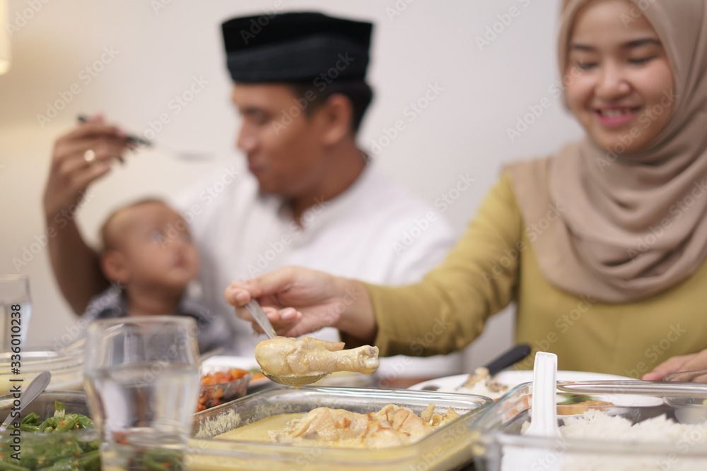 family having early breakfast before dawn. sahoor or sahur on ramadan. hand grab some chicken curry family having early breakfast before dawn. sahoor or sahur on ramadan. hand grab some chicken curry