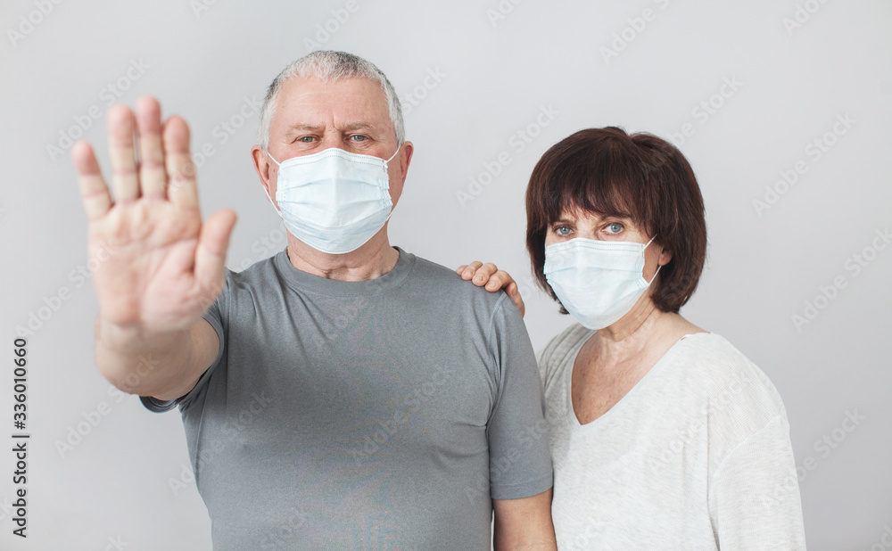 Couple of elderly people in medical masks in pandemic Coronavirus