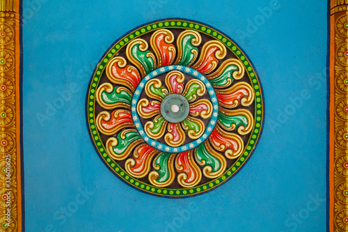 Ceiling of Meenakshi Sundareswarar Temple in the South India, beautiful vintage ceiling paintings with pattern and lamp in the center in an Indian temple
