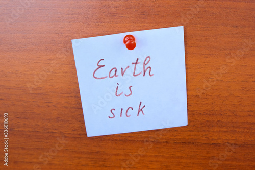 White sticker with the inscription "Earth is sick"