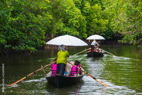 Villagers modified the charcoal boat as a service boat, bringing tourists to see the mangrove forest in Ko Lanta, Krabi, Thailand.