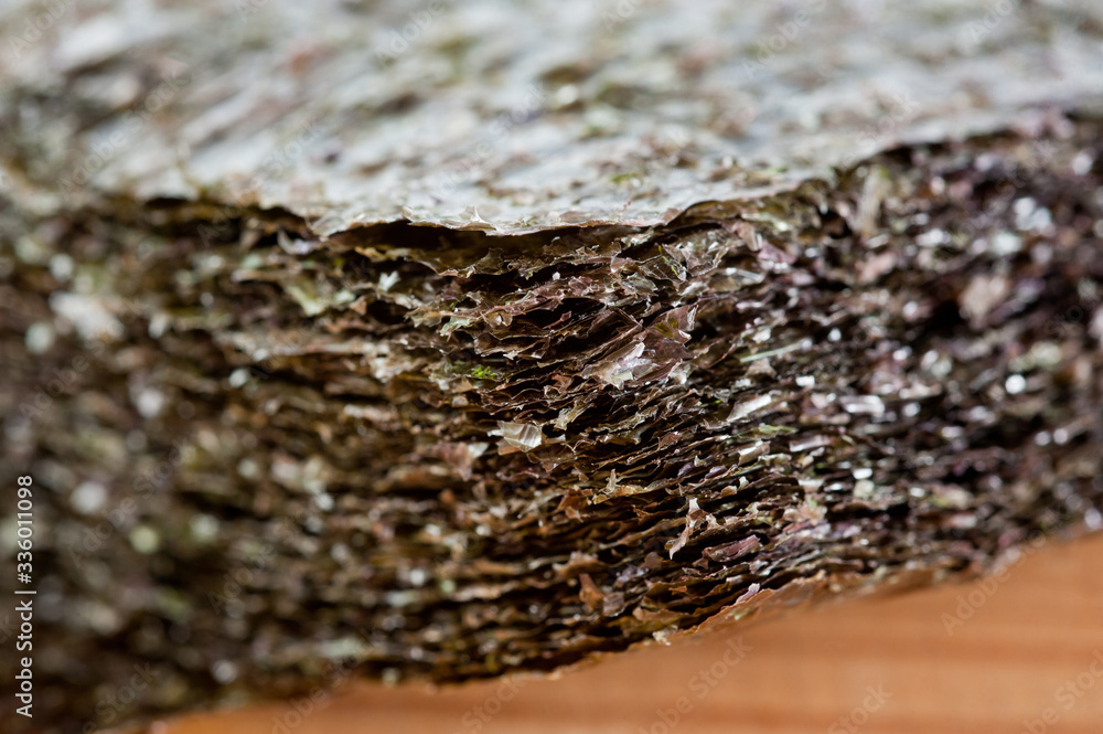 Nori seaweed dried in flat sheets. For making sushi, rolls and other dishes. Background for asian food. Nori seaweed dried in flat sheets. For making sushi, rolls and other dishes. Background for asian food.