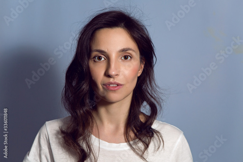 portrait of a brunette girl on a blue background