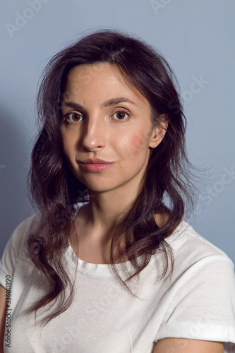 portrait of a brunette girl on a blue background