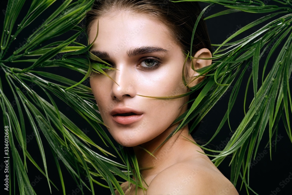 Naklejka premium beautiful woman green leaves nature rest