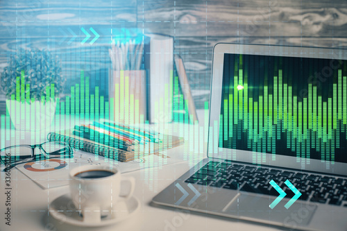 Financial graph colorful drawing and table with computer on background. Double exposure. Concept of international markets.