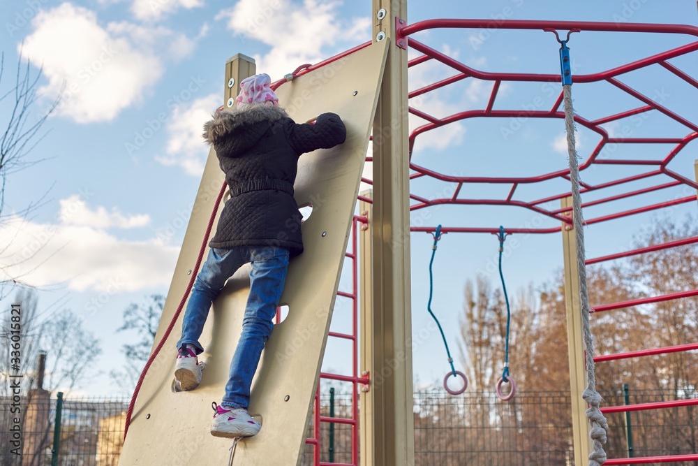 Girl child of 8, 9 years old on outdoor sports equipment, childrens playground Girl child of 8, 9 years old on outdoor sports equipment, childrens playground