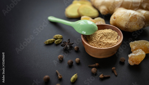 Ginger root  spices on a black background. The concept of healthy nutrition  protection from viruses  increased immunity during coronavirus quarantine  super nutrition. Selective focus.