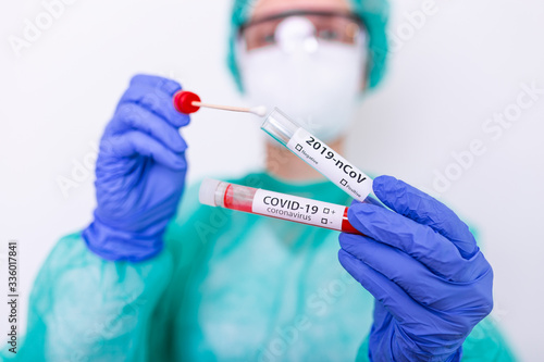 COVID-19 Nasal swab laboratory test in hospital lab  Nurse holding test tube with blood for 2019-nCoV analyzing. Novel Chinese Coronavirus blood test Concept.