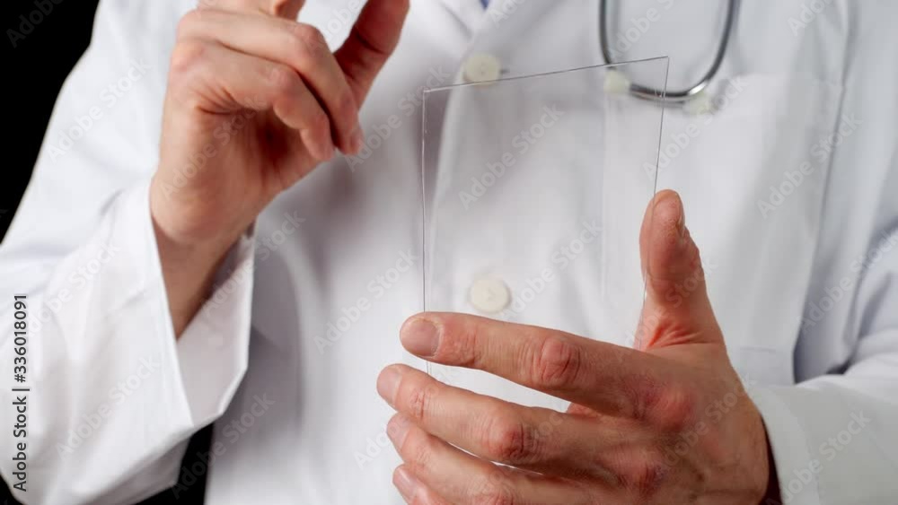 Cropped view of doctor sliding on transparent phone screen. Close up view of man using screen on black background. Virtual screen concept Cropped view of doctor sliding on transparent phone screen. Close up view of man using screen on black background. Virtual screen concept