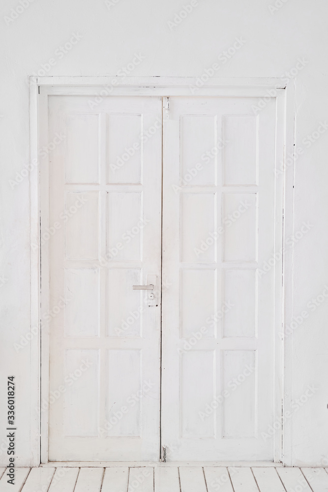 Old-style white wooden door. interior apartment. Wooden floor made of planks