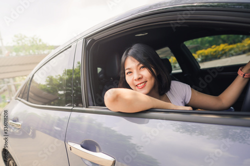 Happy Asian woman driving her new car © interstid