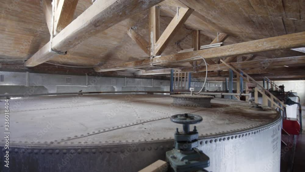 Large stainless steel alcoholic beverages distilling tanks in old