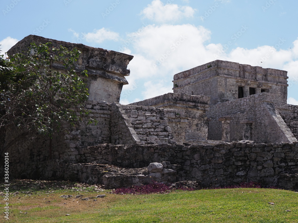 Stony temple of god of winds at TULUM city at Mexico on grassy field