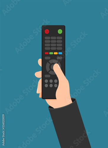 Human hand with black remote TV Control photo