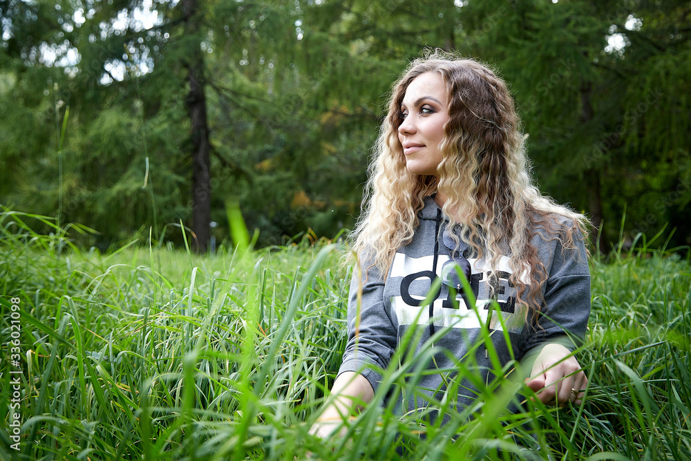 Portrait of young woman with long blonde hair in the Park Portrait of young woman with long blonde hair in the Park