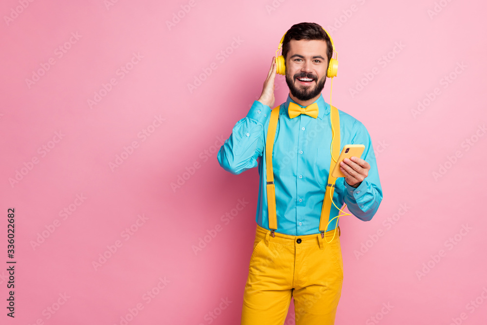 Portrait of his he nice attractive cheerful cheery bearded guy meloman wearing mint shirt listening pop stereo sound enjoying leisure spending free time isolated over pastel pink color background Portrait of his he nice attractive cheerful cheery bearded guy meloman wearing mint shirt listening pop stereo sound enjoying leisure spending free time isolated over pastel pink color background