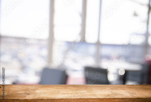 Wooden table top on a window glass blur with a view on the background. Street. To display product montage
