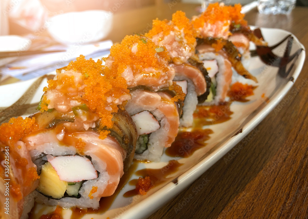 California Sushi roll. Japanese cuisine. made of fresh raw salmon, eel, avocado California Sushi roll. Japanese cuisine. made of fresh raw salmon, eel, avocado