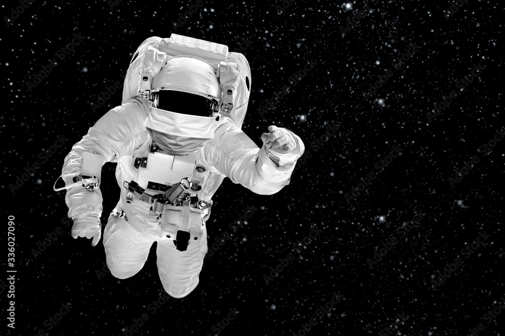 astronaut flies over the in space masked with the image of the flag Coronavirus and Air pollution pm2.5 concept. COVID-19. astronaut flies over the in space masked with the image of the flag Coronavirus and Air pollution pm2.5 concept. COVID-19.