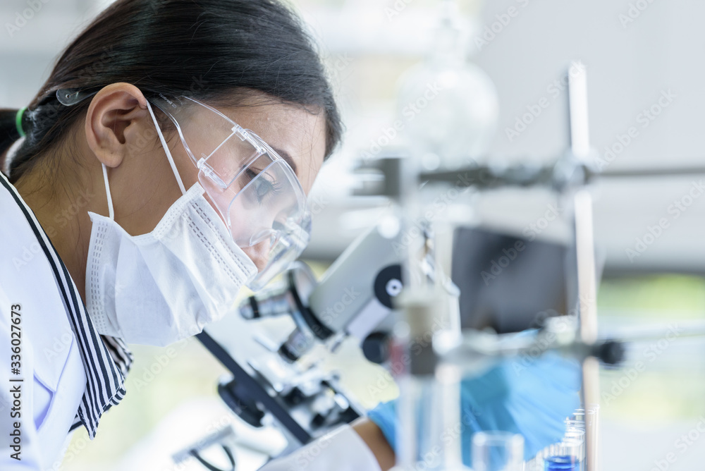 Asian young girl student scientist researching and learning in a laboratory. Asian young girl student scientist researching and learning in a laboratory.