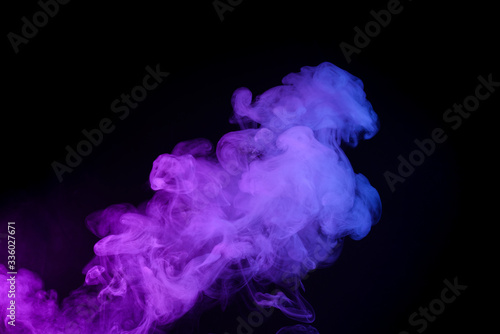 Colorufl puff of smoke isolated on black background photo