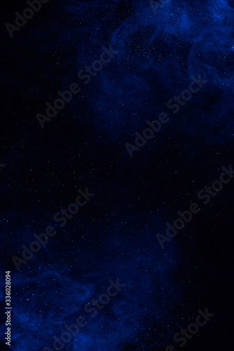 Cosmic galaxy fantasy background with blue clouds and shiny stars