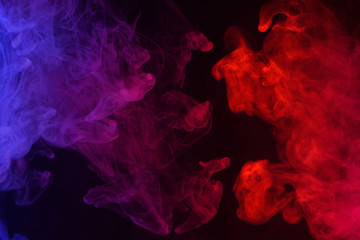 Multicolored smoke clouds flowing dark abstract background