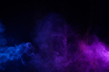 Blue and purple smoke with shiny glitter particles abstract background