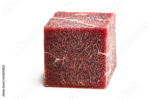 Piece of frozen meat cubic shape concept of routinely eaten food photo
