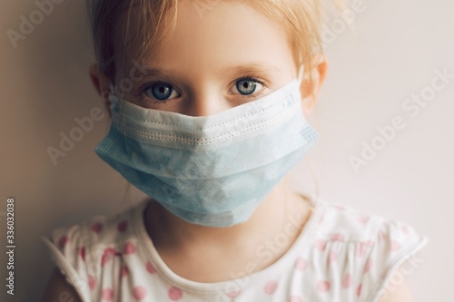 little girl with mask. A little child wearing a face mask observes. Stop coronavirus. Stay home. Covid-19