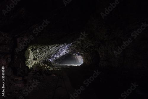 Underground gold quartz mine tunnel with light