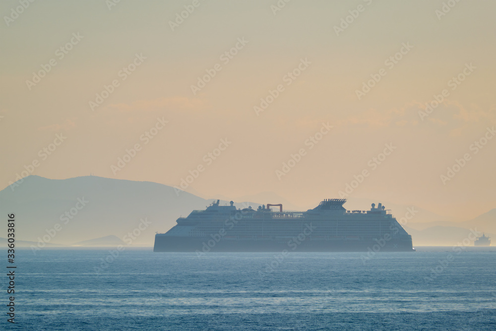 Cruise liner ship silhouette in Mediterranea sea. Aegean sea, Greece Cruise liner ship silhouette in Mediterranea sea. Aegean sea, Greece
