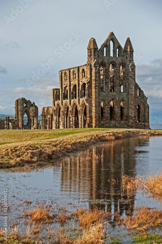 Ancient gothic english abbey with reflection in lake