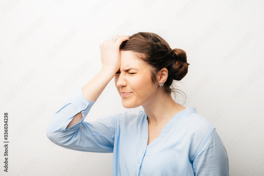 The girl headache, with hand on her head. Isolated on a white background