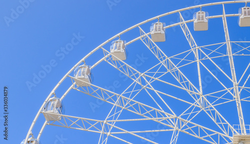 Ferris wheel in the blue sky . view the city from a height. entertainment on vacation .