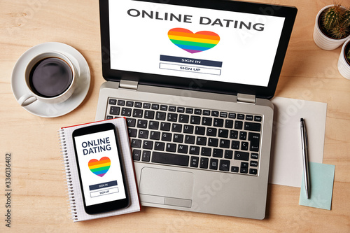 LGBT dating app concept on laptop and smartphone screen over wooden table. Gay online dating. Top view