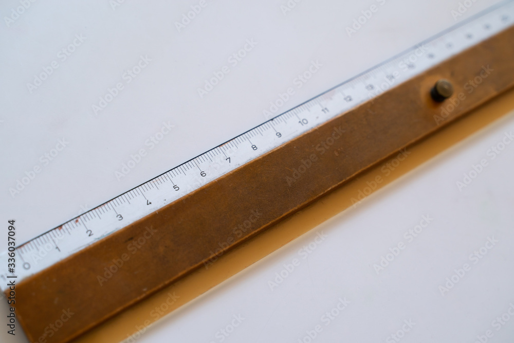 closeup macro photo of wooden old Ruler on white neutral background
