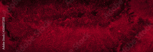 Dark saturated burgundy watercolor background with torn strokes and uneven spots. Trendy color texture. Abstract persian red background for design, layouts and patterns.