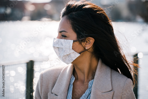 woman wearing selfmade protection mask outside in sun photo