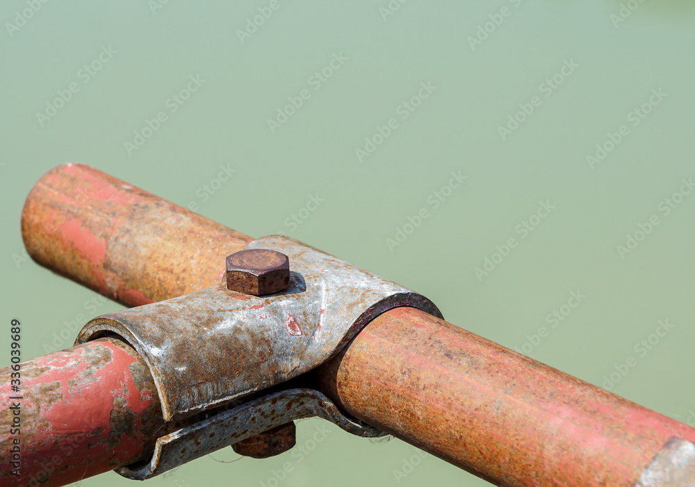 Scaffolding pipe clamp and parts, An important part of building strength to scaffold clamps in used close up on construction site,platforms for stage structure support . Scaffolding pipe clamp and parts, An important part of building strength to scaffold clamps in used close up on construction site,platforms for stage structure support .