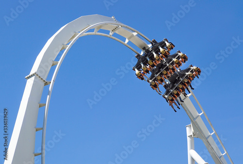 Rollercoaster Ride and loop against blue sky