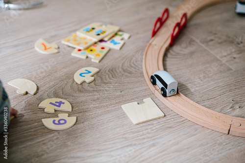 Wooden toys with railway train and numbers on a playground indoor wooden floor