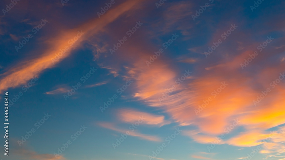 beautiful blue sky with golden clouds blurred by the wind as a natural background