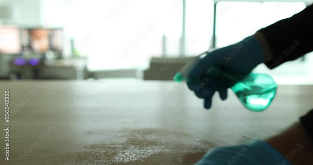 Disinfection and cleaning of surfaces for Coronavirus COVID-19 . Disinfecting with household cleaner Spray Bottle surface of table at home office or kitchen for corona virus COVID-19.