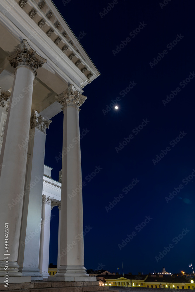 Night view of architectural columns and moon in Helsinki with no people