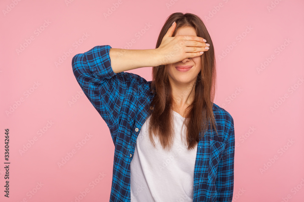 I'm not watching! Portrait of confused girl in checkered shirt covering eyes with hand, frightened to look, her face expressing disgust and shock. indoor studio shot isolated on pink background I'm not watching! Portrait of confused girl in checkered shirt covering eyes with hand, frightened to look, her face expressing disgust and shock. indoor studio shot isolated on pink background
