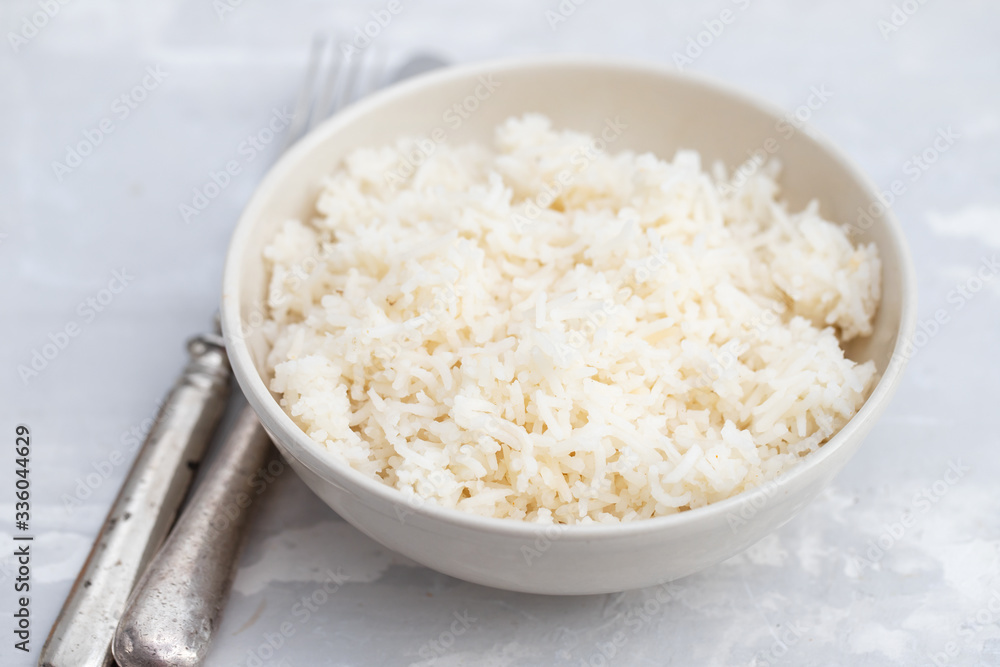 boiled rice in the small bowl on ceramic background boiled rice in the small bowl on ceramic background