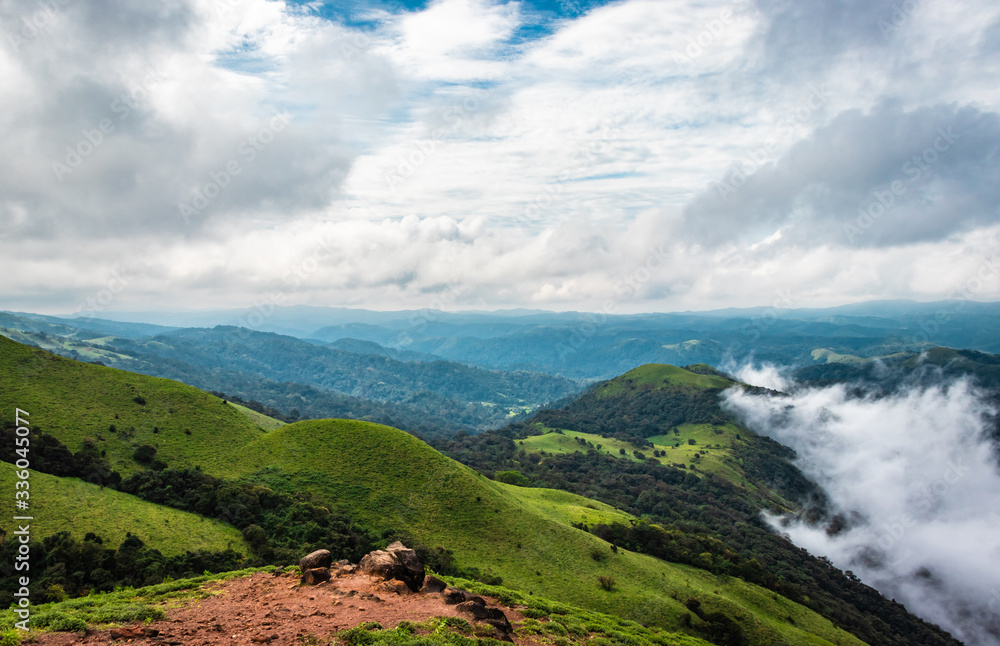 Cloud layers on mountain horizon with green grass Cloud layers on mountain horizon with green grass